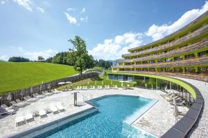 a resort with a swimming pool and a resort at DAS SIEBEN - Adults Only in Bad Häring