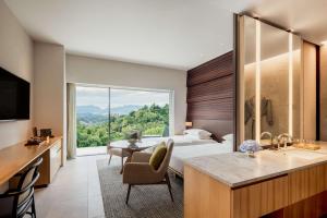 コタキナバルにあるHyatt Centric Kota Kinabaluのベッドと大きな窓が備わるホテルルームです。