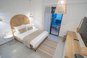 a bedroom with a large bed and a wooden table at Shikma Ella Sun in Eilat +25 photos