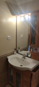 a bathroom with a sink and a large mirror at apart paz in Torrevieja