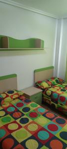 two beds sitting next to each other in a bedroom at apart paz in Torrevieja