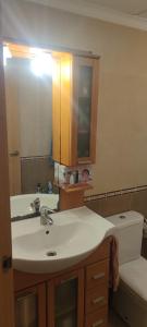 a bathroom with a sink and a mirror and a toilet at apart paz in Torrevieja