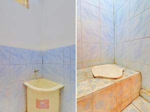y baño alicatado con aseo y lavamanos. en SPOT ON 92404 Pondok Ai en Cupel