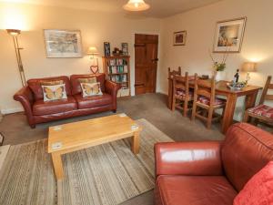 a living room with a couch and a table at Miller's Retreat in Alnwick