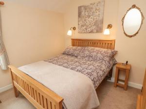 a bedroom with a bed and a mirror at Miller's Retreat in Alnwick