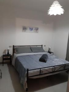 1 dormitorio con 1 cama grande con manta azul en Home Sweet Home en Castel SantʼElia