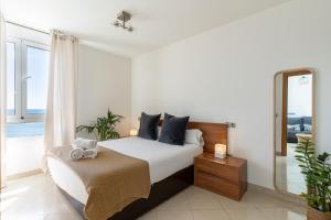 1 dormitorio con 1 cama grande y espejo en MONKÓ ON THE ROCK en Torremolinos