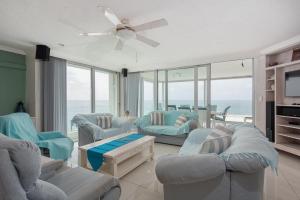 a living room with two couches and a ceiling fan at CAPRI 15 in Margate