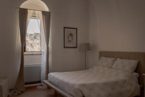 Postel nebo postele na pokoji v ubytování Il Vicinato, casa vacanza immersa nel cuore dei Sassi