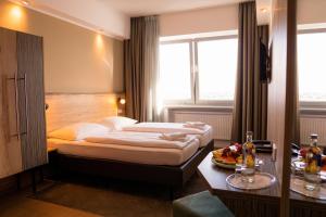 Postel nebo postele na pokoji v ubytování Hotel Sportforum