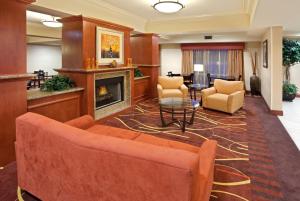 a lobby with a couch and a fireplace at Holiday Inn Express and Suites Sumner, an IHG Hotel in Sumner