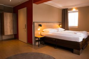 a hotel room with a bed and a window at Hotel Sportforum in Rostock