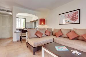 a living room with a couch and a table at Grupotel Club Menorca in Son Xoriguer