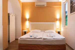 a bedroom with a large white bed with two pillows at Hotel Metro in Budapest