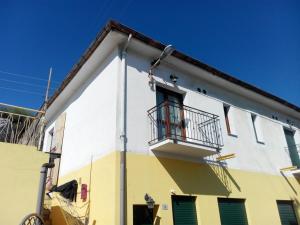 a white and yellow building with a balcony at Ada Home in Sanremo