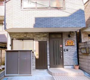 a front door of a house with a brown door at D27-Outstanding convenience 4DK/ Shinjuku Okubo in Tokyo