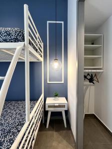 a small room with two bunk beds and a table at Maritime Apartamentos Valencia in Valencia