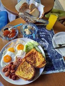 a plate of breakfast food on a table at Villa Nina Hotel & Lounge bar in Skopje