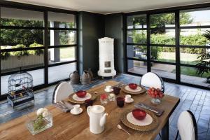 a dining room with a table and chairs and windows at B&B Puntodivista in Chieri