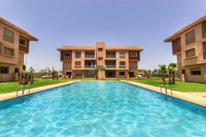 a swimming pool in front of a building at Wonderful Apartment in the best area of ​​Marrakech in Marrakech