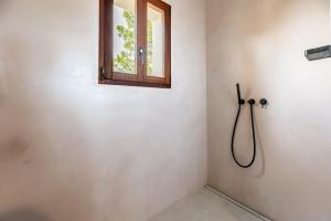 a shower in a bathroom with a window at Casa Juliarina in Sant Josep de sa Talaia +23 photos
