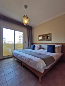 a bedroom with a large bed with a large window at X1 by Smallville in Beirut