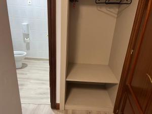 a cupboard in a bathroom with a toilet at Pension Norte in Portugalete