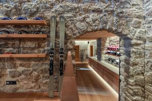 a room with a stone wall with wine racks at Cresta Palace Celerina in Celerina