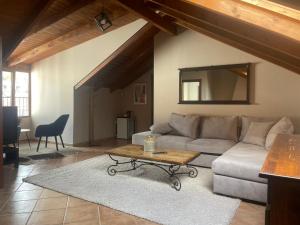 a living room with a couch and a table at Tzovolos Apartments in Kalavrita