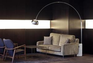 a living room with a couch and two chairs and a lamp at c-hotels Ambasciatori in Florence