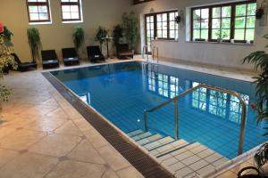 a large swimming pool with blue water at Landgasthaus & Hotel Kurfer Hof in Bad Endorf