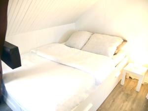 a white bed in a small room with a table at Soul House in Sens