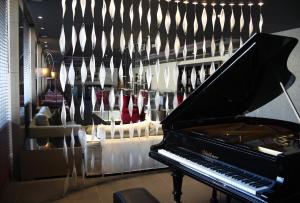 a room with a piano and many pairs of shoes at c-hotels Ambasciatori in Florence