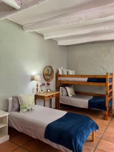 a bedroom with two bunk beds and a mirror at Rivers Own Guest Lodge in Breerivier