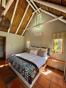 a bedroom with a large bed in a room at Rivers Own Guest Lodge in Breerivier