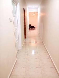a hallway with a tile floor and white walls at cozy apartment Aircon Downtown Aswan in Aswan