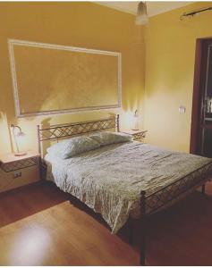 a bedroom with a bed and two lamps and a large window at B&B Lucius in Pompei