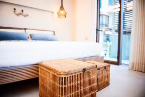 a bedroom with a bed with a wicker trunk next to it at Vistamare Suite & Room in Marina di Campo