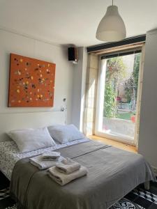 Posteľ alebo postele v izbe v ubytovaní Le bonheur de la campagne à la ville - Grand studio en plein coeur de la ville