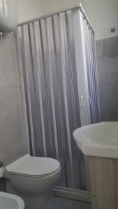 een badkamer met een douche, een toilet en een wastafel bij Casa Athena in Crotone