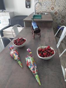 une table avec deux bols de cerises et une voiture-jouets sur elle dans l'établissement Apartamentos La Chaparrina del Jerte, à El Torno