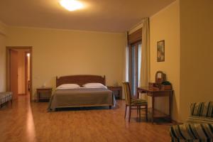 Postel nebo postele na pokoji v ubytování Ruggiero Park Hotel