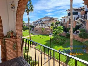 a balcony with a view of a yard with houses at Apartamento 2 Al Andalus Resort - Vera Playa in Vera
