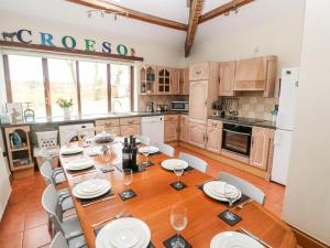 a dining room with a wooden table and chairs at The Barn at Harrolds Farm in Jeffreston +25 photos
