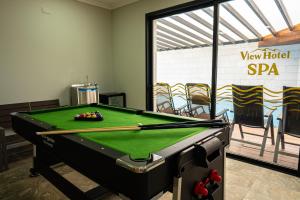 a pool table in a room with a pool cue at view hotel in Majdal Shams