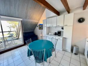 a kitchen with a table and chairs in a room at Appartement bord de mer à Saint-Pierre-Quiberon avec balcon et garage - FR-1-478-181 in Saint-Pierre-Quiberon