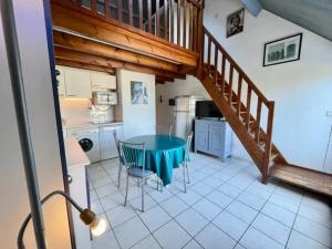 a kitchen with a table and a staircase in a room at Appartement bord de mer à Saint-Pierre-Quiberon avec balcon et garage - FR-1-478-181 in Saint-Pierre-Quiberon +3 photos