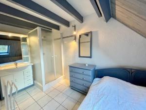 a bedroom with a blue bed and a sink at Appartement bord de mer à Saint-Pierre-Quiberon avec balcon et garage - FR-1-478-181 in Saint-Pierre-Quiberon +4 photos