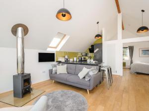 a living room with a couch and a stove at Spires in Truro