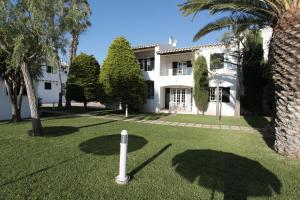 a house with a golf course in the yard at Grupotel Club Menorca in Son Xoriguer